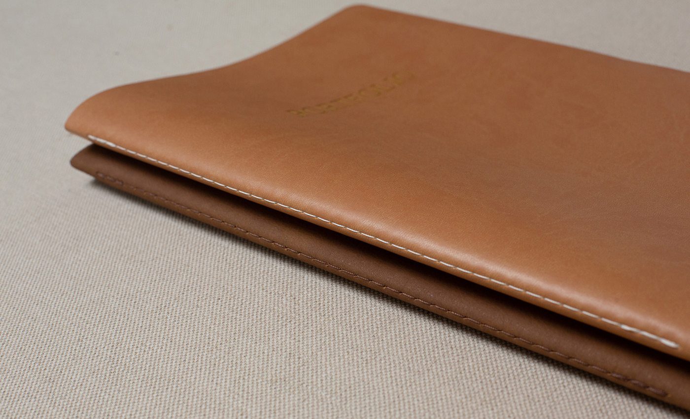 Italian leather cover close-up showing hand-sewn white stitching detail