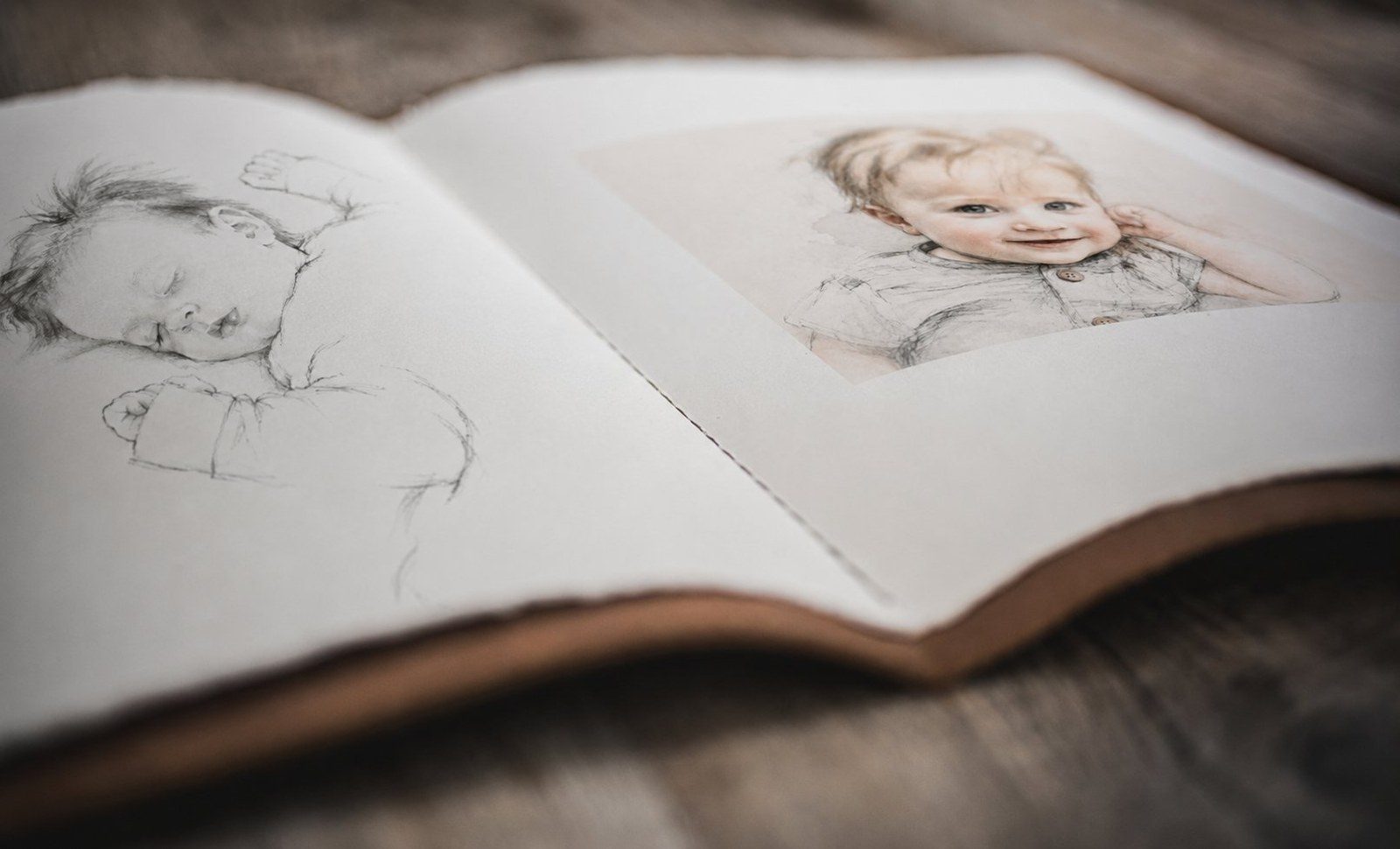 First Light heirloom storybook open spread showing pencil and watercolor illustrations on deckled cotton paper