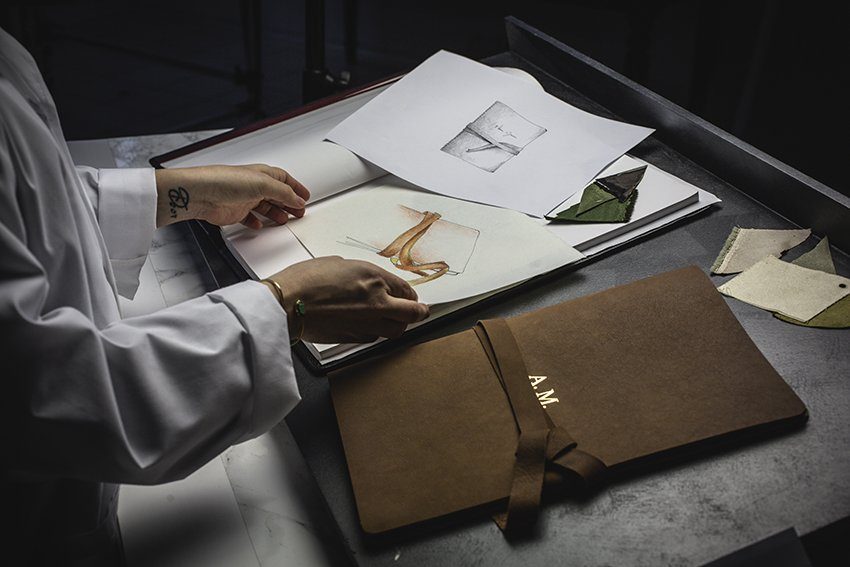 Artisan reviewing illustrations in the studio